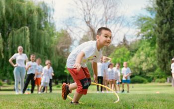 Kids enjoy outdoor fun with hula hoops in a vibrant park setting.