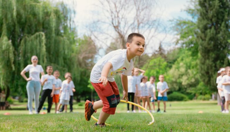Kids enjoy outdoor fun with hula hoops in a vibrant park setting.